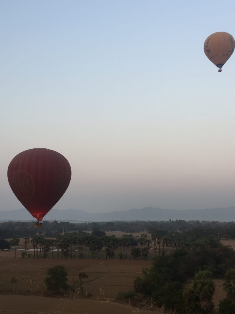 Two hot air balloons float in the dusky blue sky over, Bagan, Myanmar