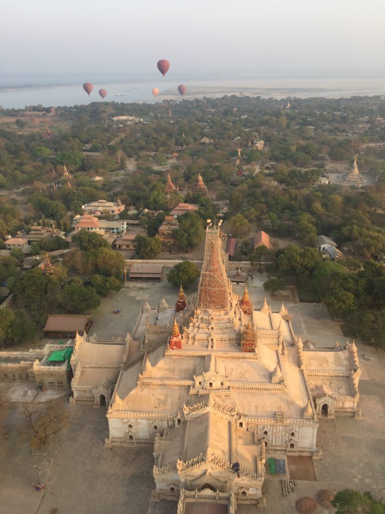 Overhead view of Ananda Temple (Phaya), Bagan, Myanmar with hot air balloons floating in the background