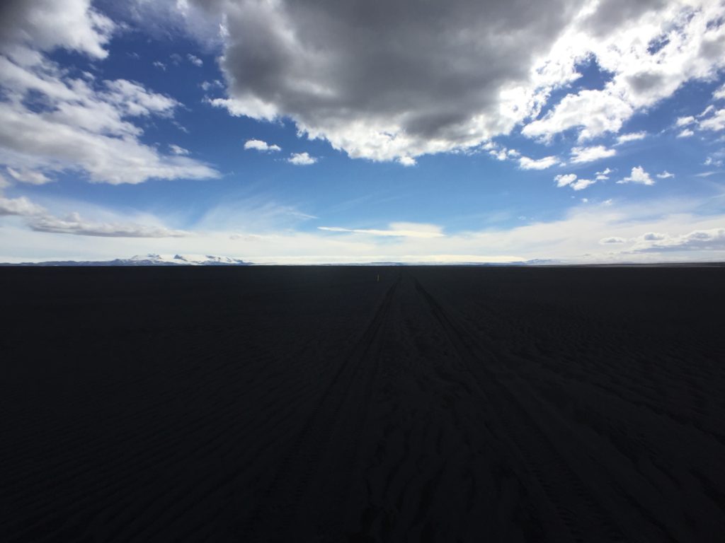 Black sand road and blue sky, Highlands, Iceland
