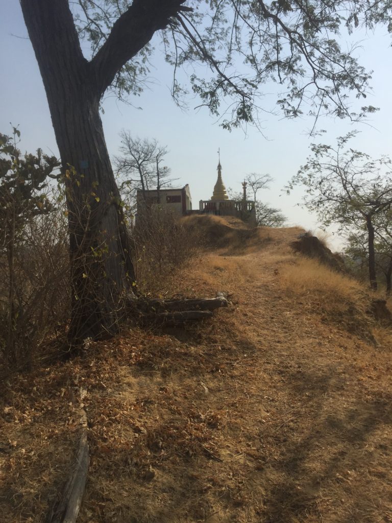 Buddhist pagoda atop a scrubby hill