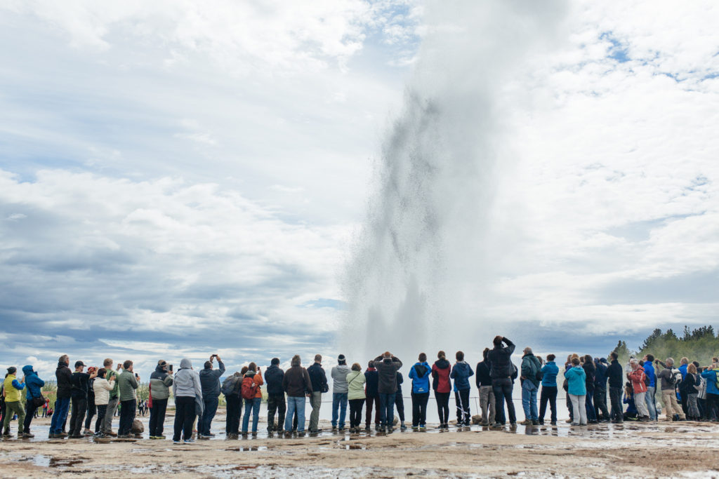 Crowds lined up side by side watching Geysir explode 