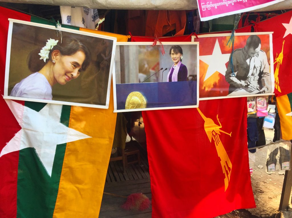 Burmese flag, the National League for Democracy flag and photos of Aung San Suu Kyi strung up beside each other