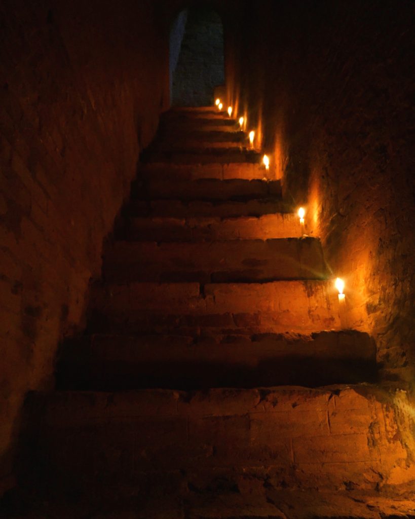 Looking up a set of candle lighted stone steps