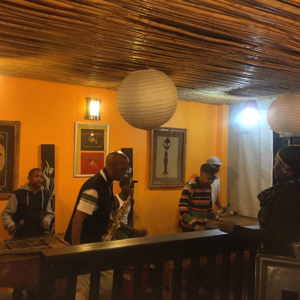 Several musicians play inside a home