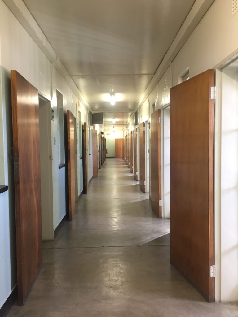 A line of prison cell doors opened