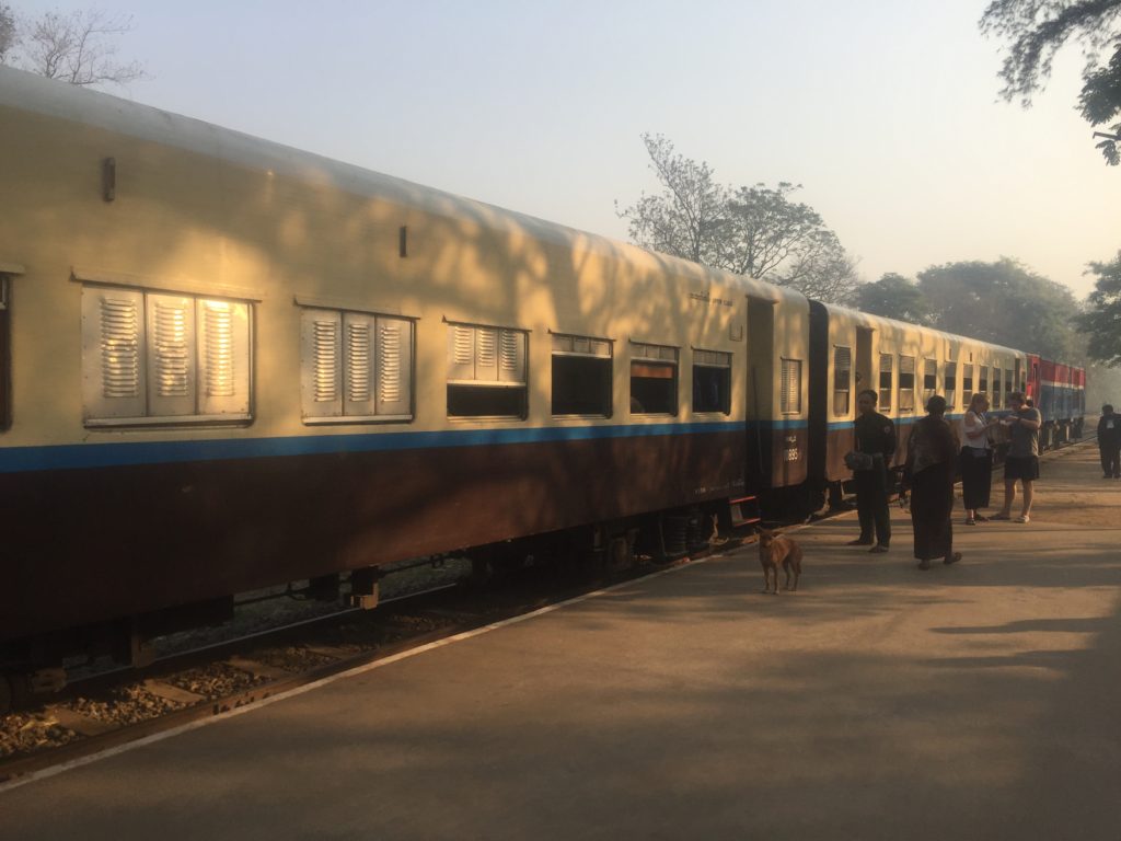 Brown and white train sits on the platform at Pyin Oo Lwin before departing for the Goteik Viaduct