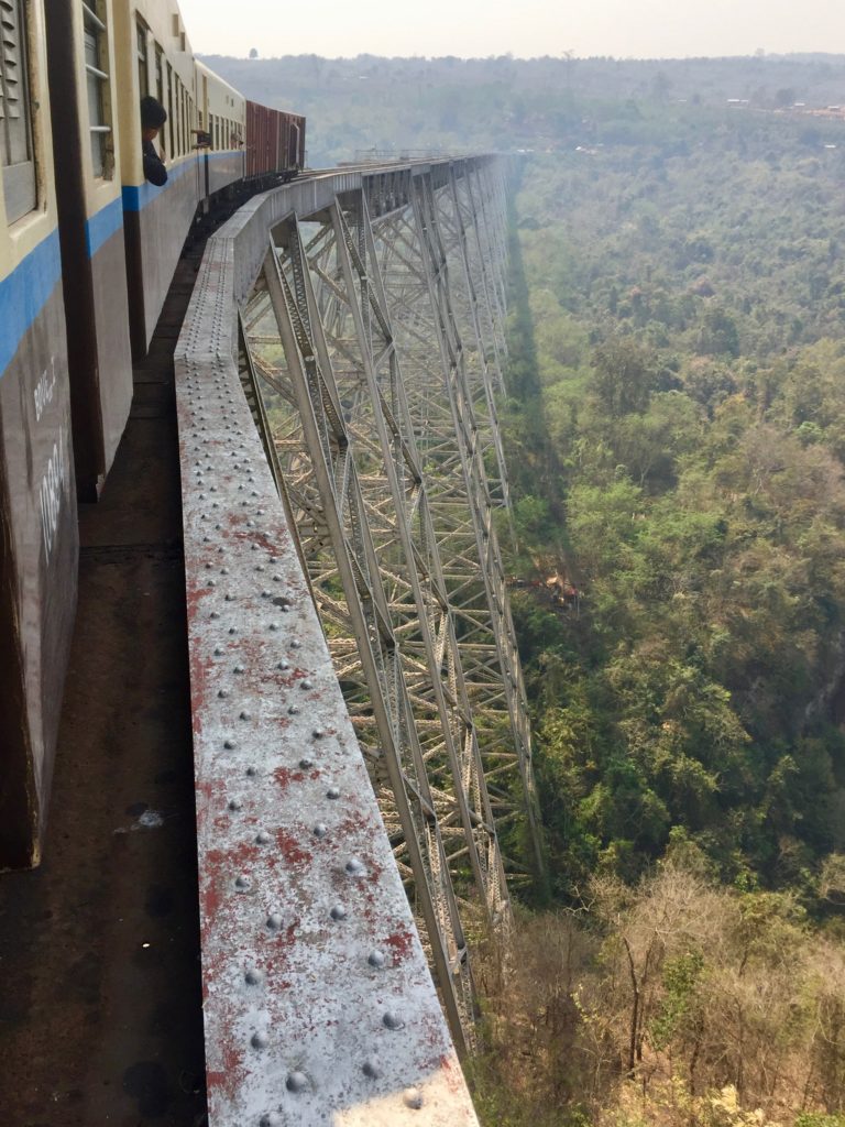 Looking out the window at the Goteik Viaduct rail bridge and train as it curves ahead