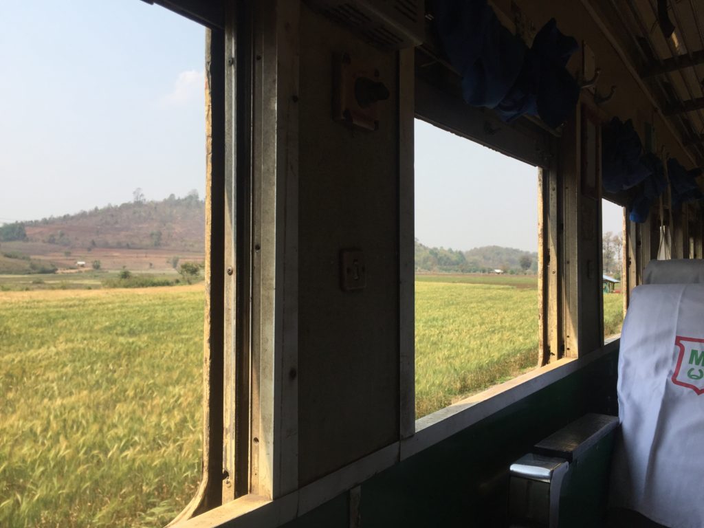 Looking out the train windows at the Burmese countryside