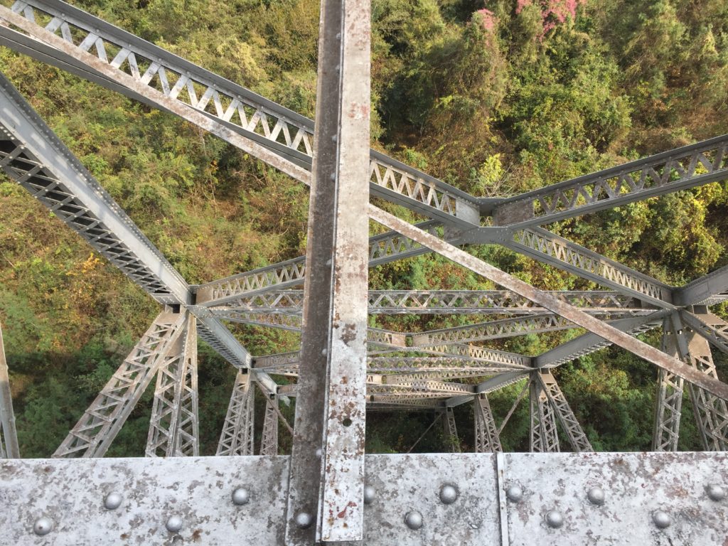 Looking down at steel trusses that form the bridge