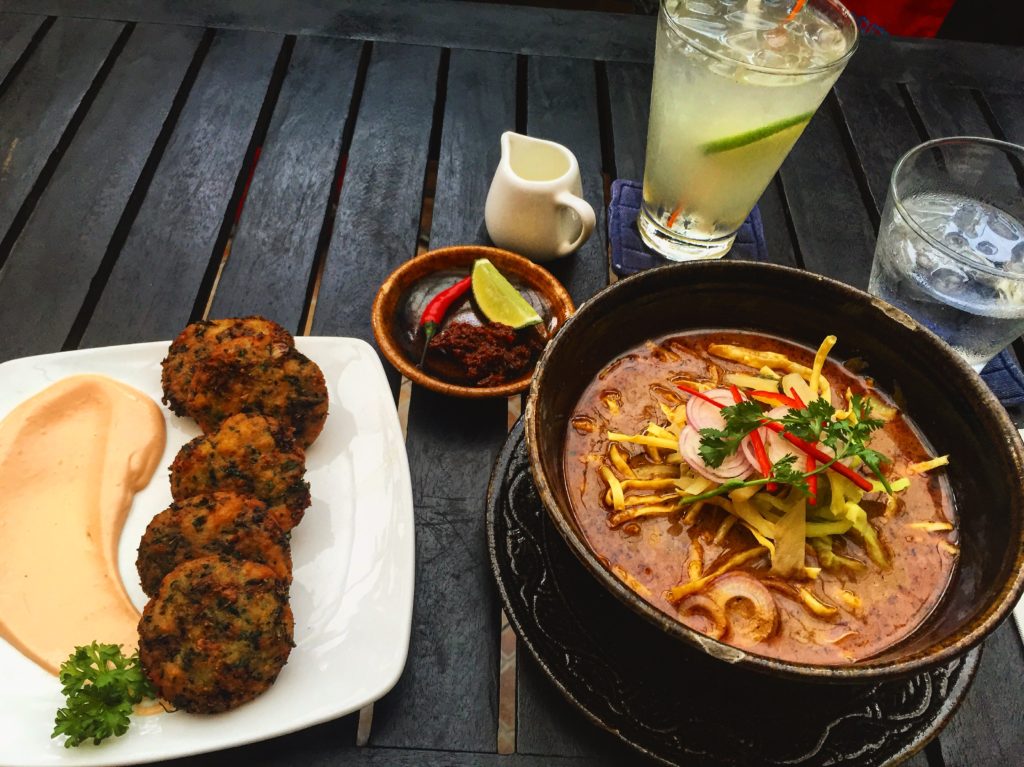Colorful overhead photo of lunch; Burmese curry, zucchini fritters & lime juice