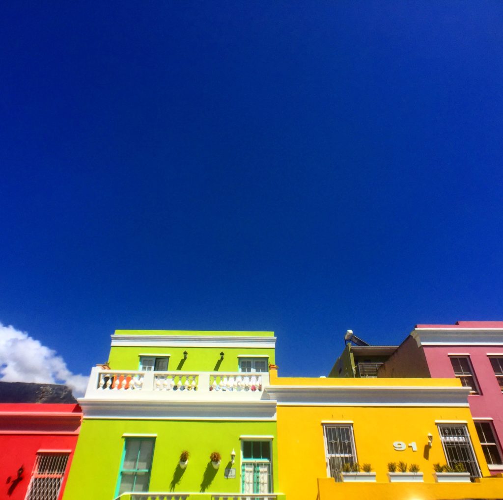 Colorful row of homes with blue a sky background in Bo-Kaap, Cape Town