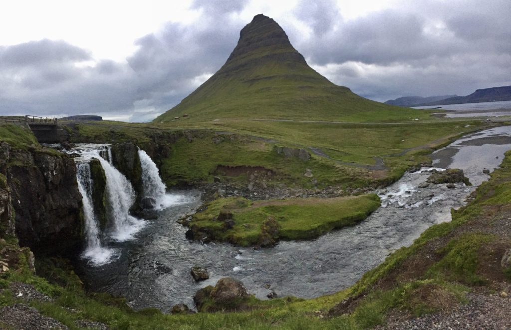 Kirkjufell in the background with Kirkjufelsfoss waterfall in the foreground in early morning light