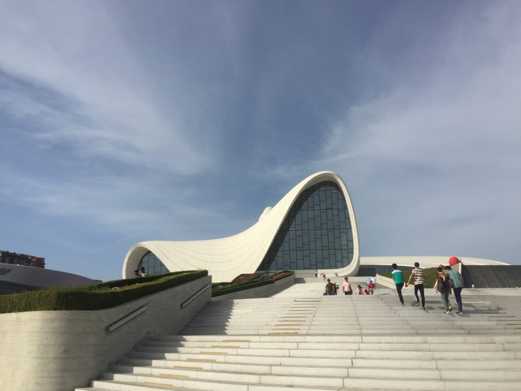 Distance photo of the entire Heydar Aliyev Center looking up from the steps