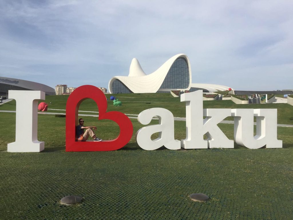 Me sitting inside the I Love Baku sign with the Heydar Aliyev Center in background